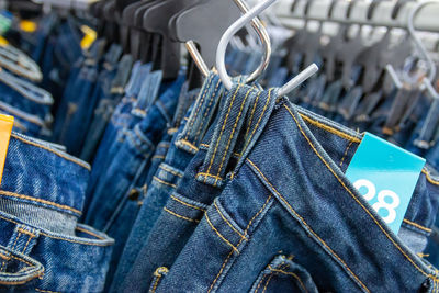 Close-up of jeans hanging in store