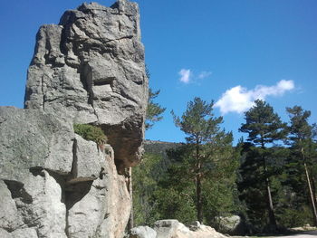 Low angle view of rock formation against blue sky