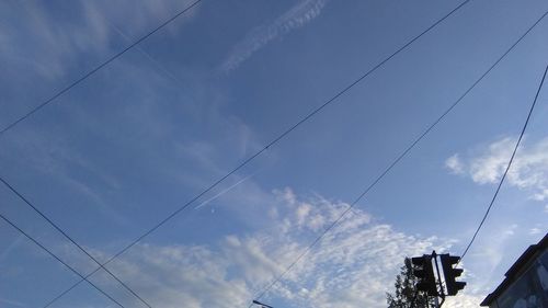 Low angle view of birds flying against sky