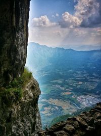 Scenic view of mountains against cloudy sky