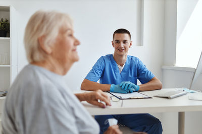 Female doctor examining patient in office