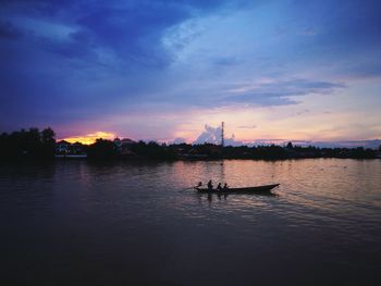 Silhouette boat in sea against sky during sunset