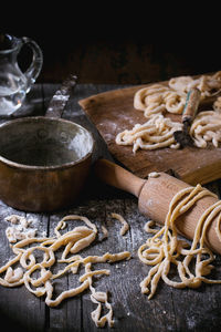 Close-up of dough with utensils on table