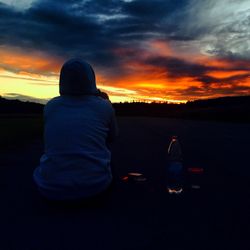 Silhouette of man against cloudy sky