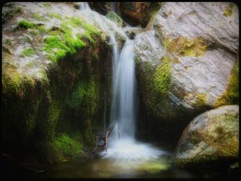 Scenic view of river flowing through rocks