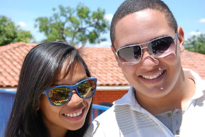 Portrait of smiling young woman wearing sunglasses