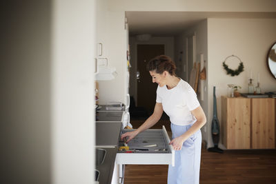 Woman standing in kitchen