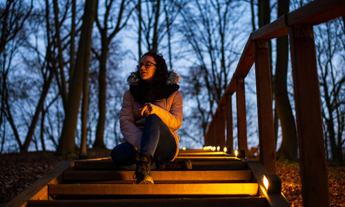 Full length of woman sitting in park