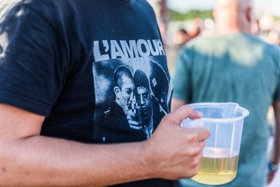 Midsection of man holding drink