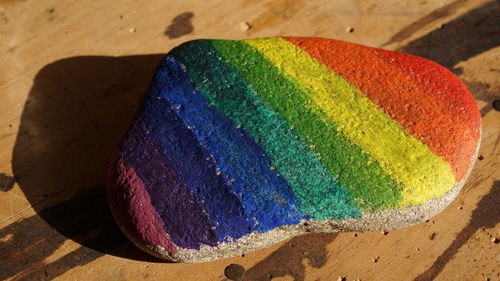 High angle view of painted multi colored rock on table