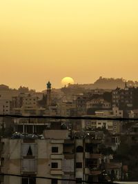 Sunset behind lebaness arabic mountain city buildings