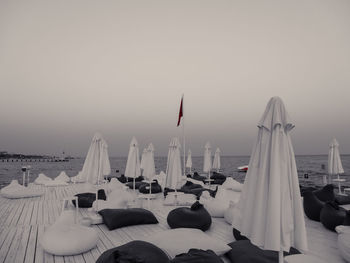 Panoramic view of flag on snow covered landscape against sky