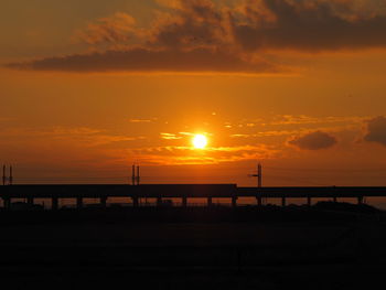 Silhouette bridge against sky during sunset