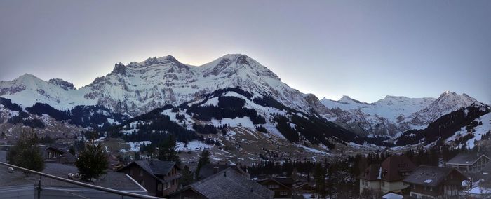 Scenic view of snowcapped mountains against clear sky