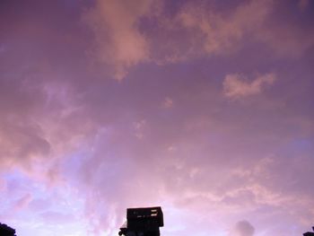 Low angle view of building against sky at sunset
