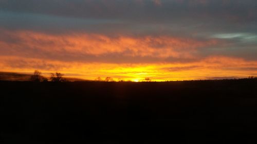 Scenic view of silhouette landscape against sky during sunset