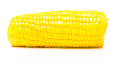 Close-up of yellow cake against white background