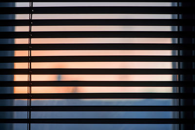 Full frame shot of window blinds during sunset