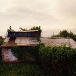 House by building against sky
