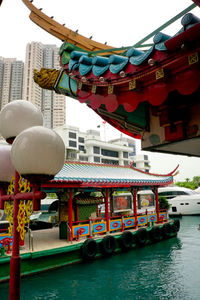 Boats in water against built structure