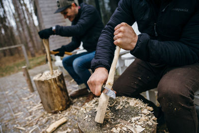 Craftsmen carving wood at workshop