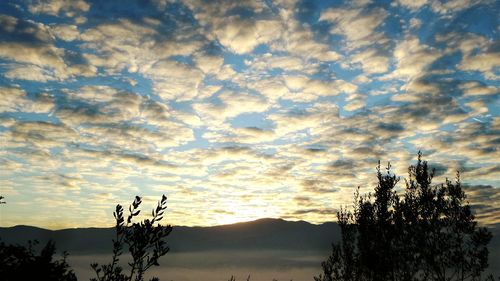 Scenic view of mountains against cloudy sky