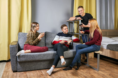 People sitting on sofa at home