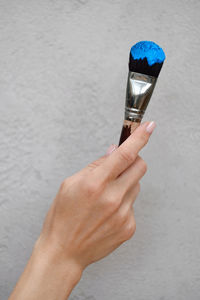 Paintbrush for acrylic and oil paints on grey wall background. bid brush stained with paint. copy