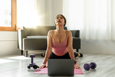 Young woman exercising in gym