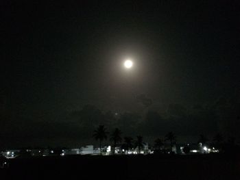 Illuminated lights against sky at night