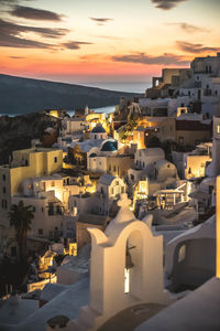 Traditional white buildings on santorini island at susnet