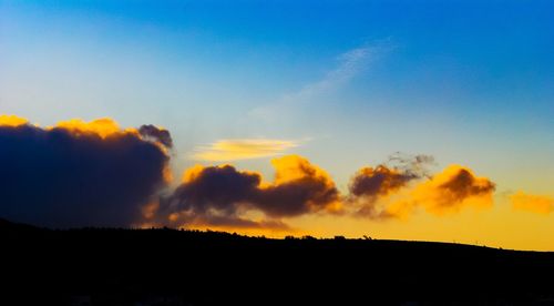 Silhouette landscape against sky during sunset
