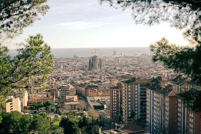 High angle view of buildings and trees against sky