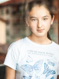 Portrait of young woman through a window