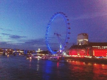 Illuminated ferris wheel at night