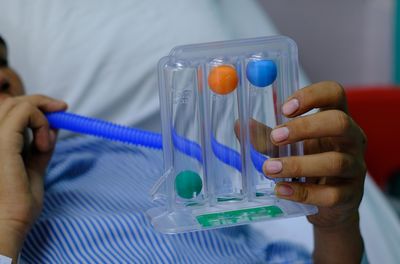 Midsection of man playing with toy