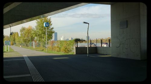 Empty road along buildings