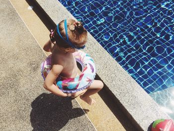 High angle view of girl walking by pool