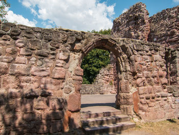 Old ruins of building against cloudy sky