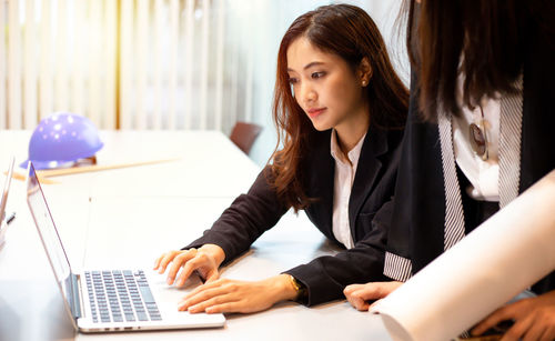 Young woman using laptop at home