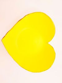 High angle view of yellow slices over white background