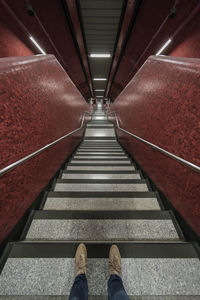 Low section of person standing on staircase