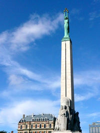 Low angle view of statue against blue sky