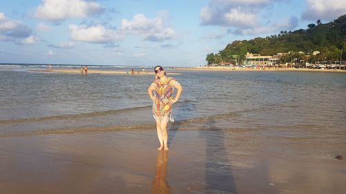 Man standing on beach against sky