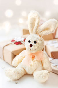 Wrapped presents with toy plush rabbit, symbol of 2023 new year.  holiday greeting card.