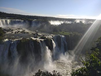 Scenic view of waterfall against sky