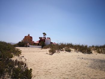 House on shore against clear sky