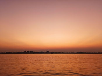 Scenic view of sea against romantic sky at sunset