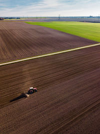 Aerial view of combine harvester on agricultural field