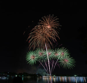 Low angle view of firework display at night